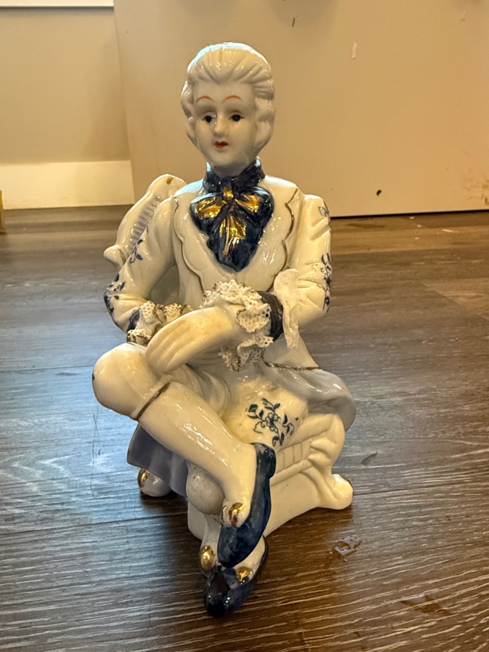 Porcelain Seated Figurine in White with Blue and Gold Accents